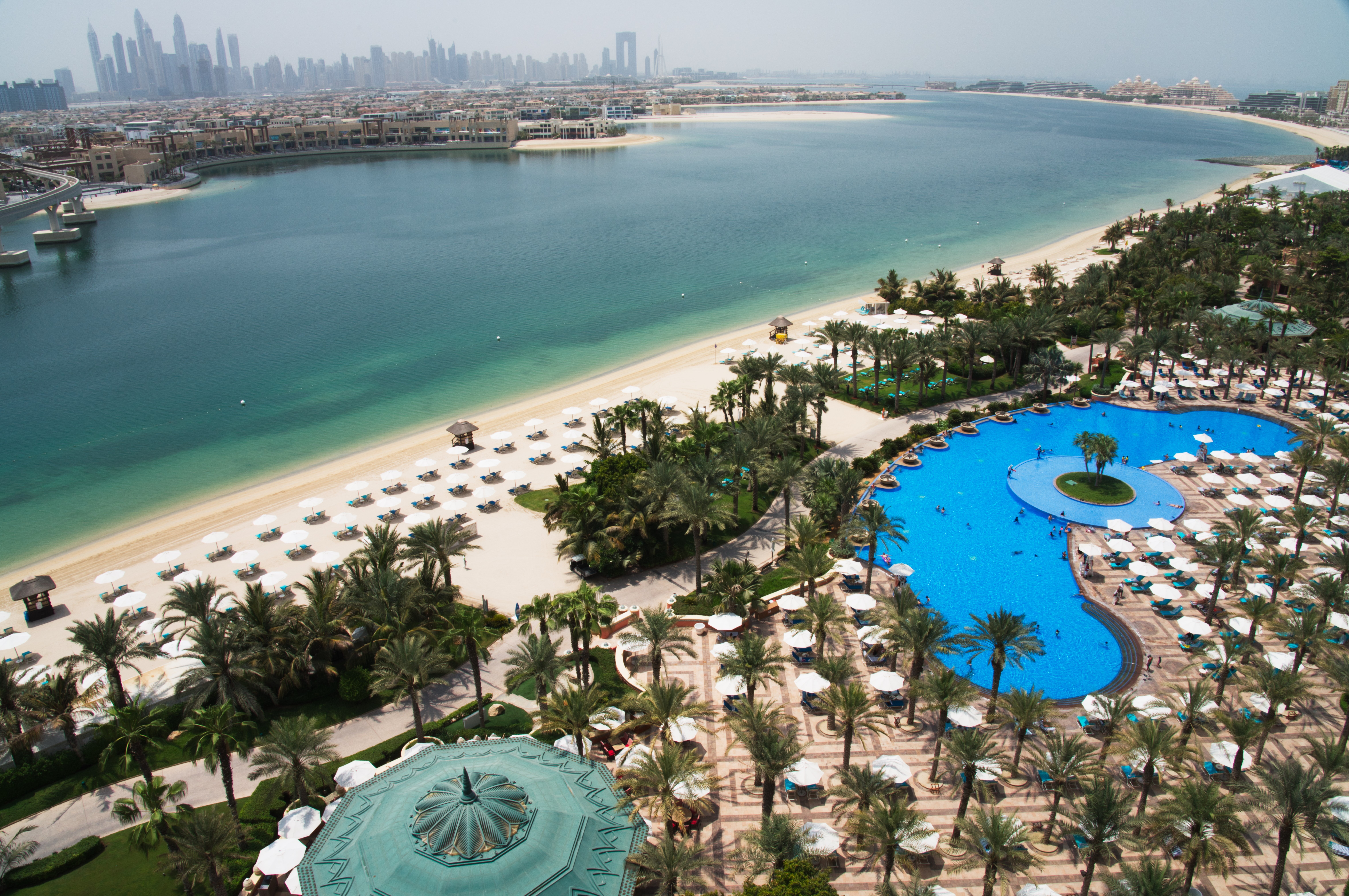 The pool and beach of the Atlantis Hotel is seen with the skyline of the Dubai Marina in the distance in Dubai, United Arab Emirates, July 14, 2020. (AP Photo/Jon Gambrell, File)