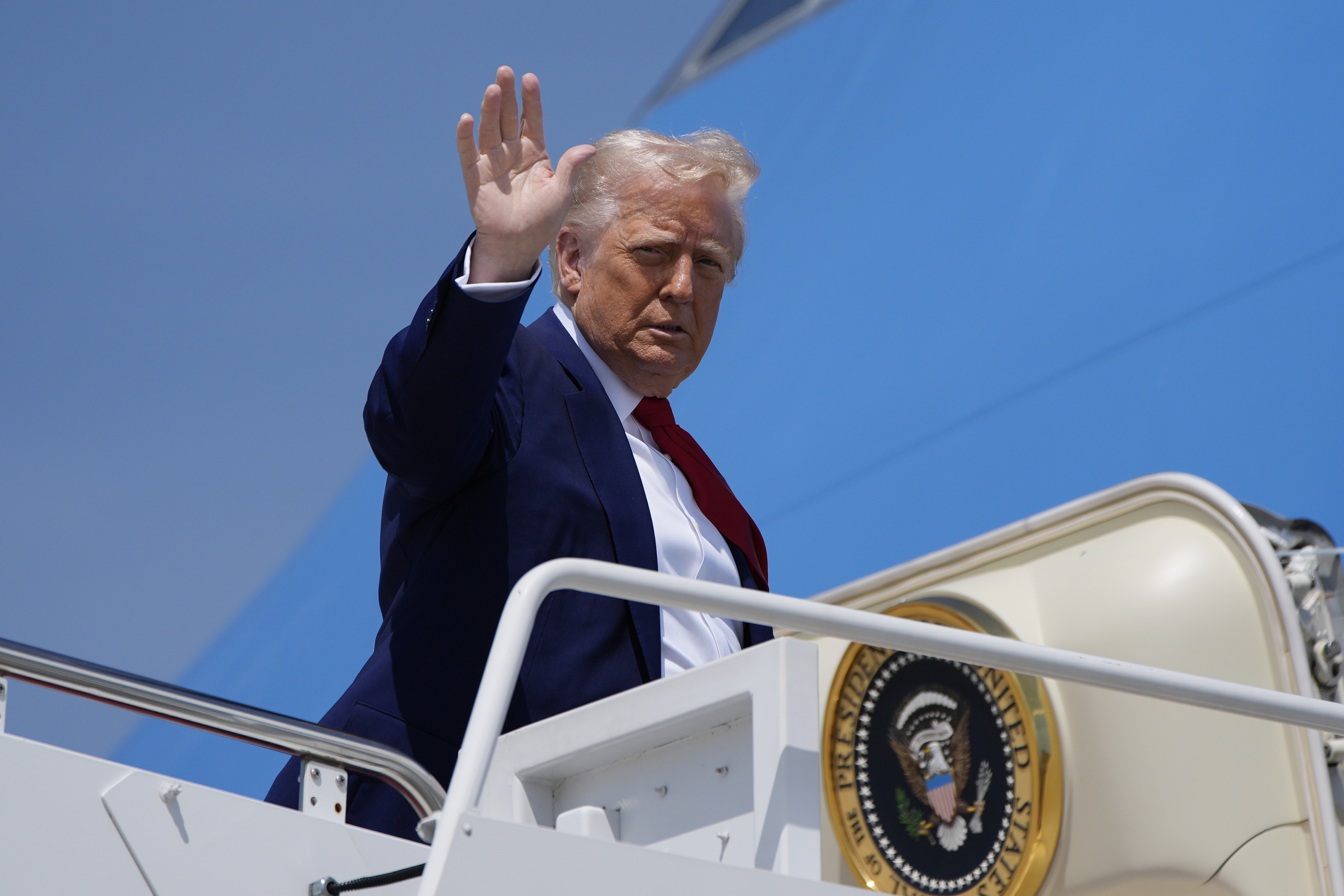 President Donald J. Trump waves as he boards Air Force One at Joint Base Andrews, MD, April 29. (AP Photo/Alex Brandon)