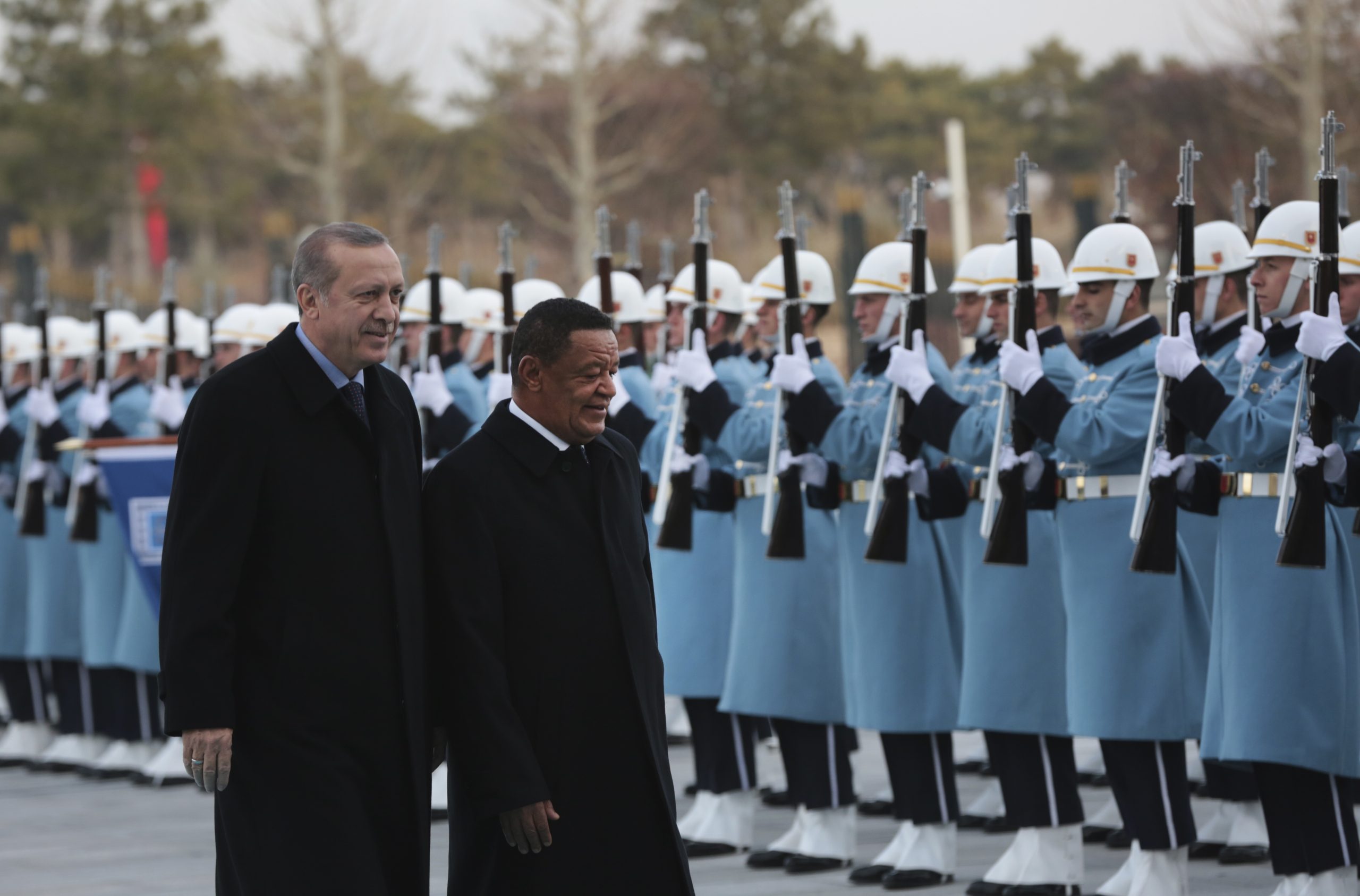 Turkey's President Recep Tayyip Erdogan, left, walks with Ethiopia's then-President Mulatu Teshome Wirtu during a welcome ceremony in Ankara, Turkey, Feb. 7, 2017. (AP Photo/Burhan Ozbilici)