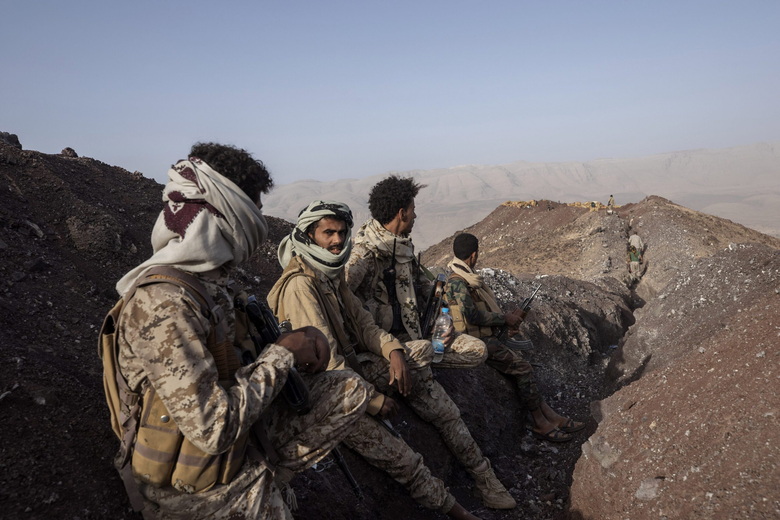 Yemeni fighters backed by the Saudi-led coalition stand at a distance from the front line after clashes with Houthi rebels near Marib, Yemen, June 20. (AP Photo/Nariman El-Mofty)