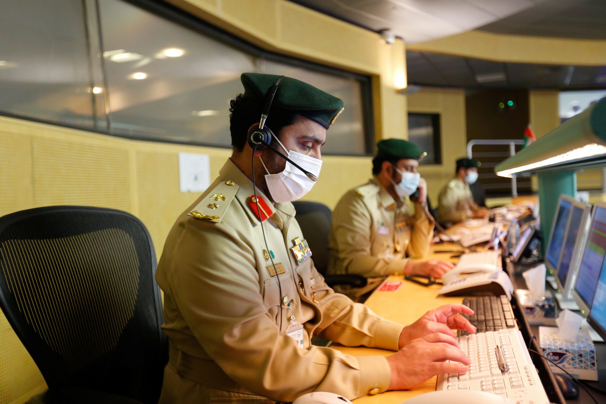 Emirati police officers work on their computers at Dubai Police Command and Control Center in Dubai, United Arab Emirates, July 26. (REUTERS/Rula Rouhana)