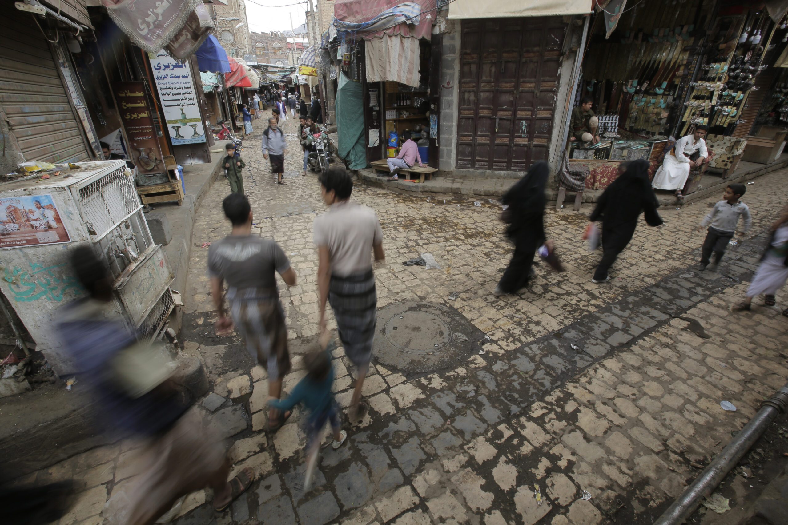 Yemenis walk past vendors in the market in the old city of Sanaa, Yemen, Sept. 28, 2019. (AP Photo/Hani Mohammed)