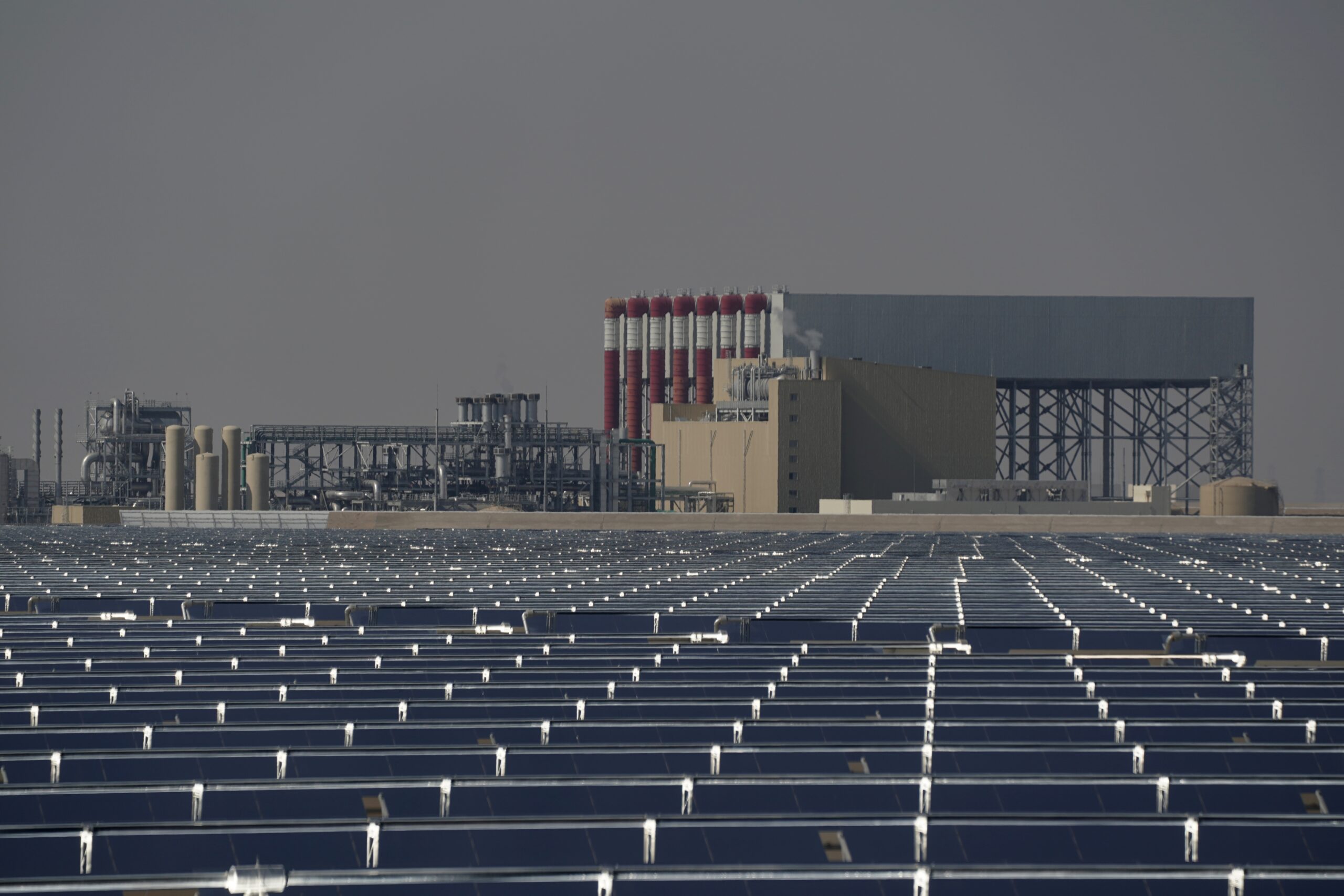 Solar panels and a power station operate at Mohammed bin Rashid Solar Park in Dubai, United Arab Emirates, Dec. 11, 2023. (AP Photo/Joshua A. Bickel)