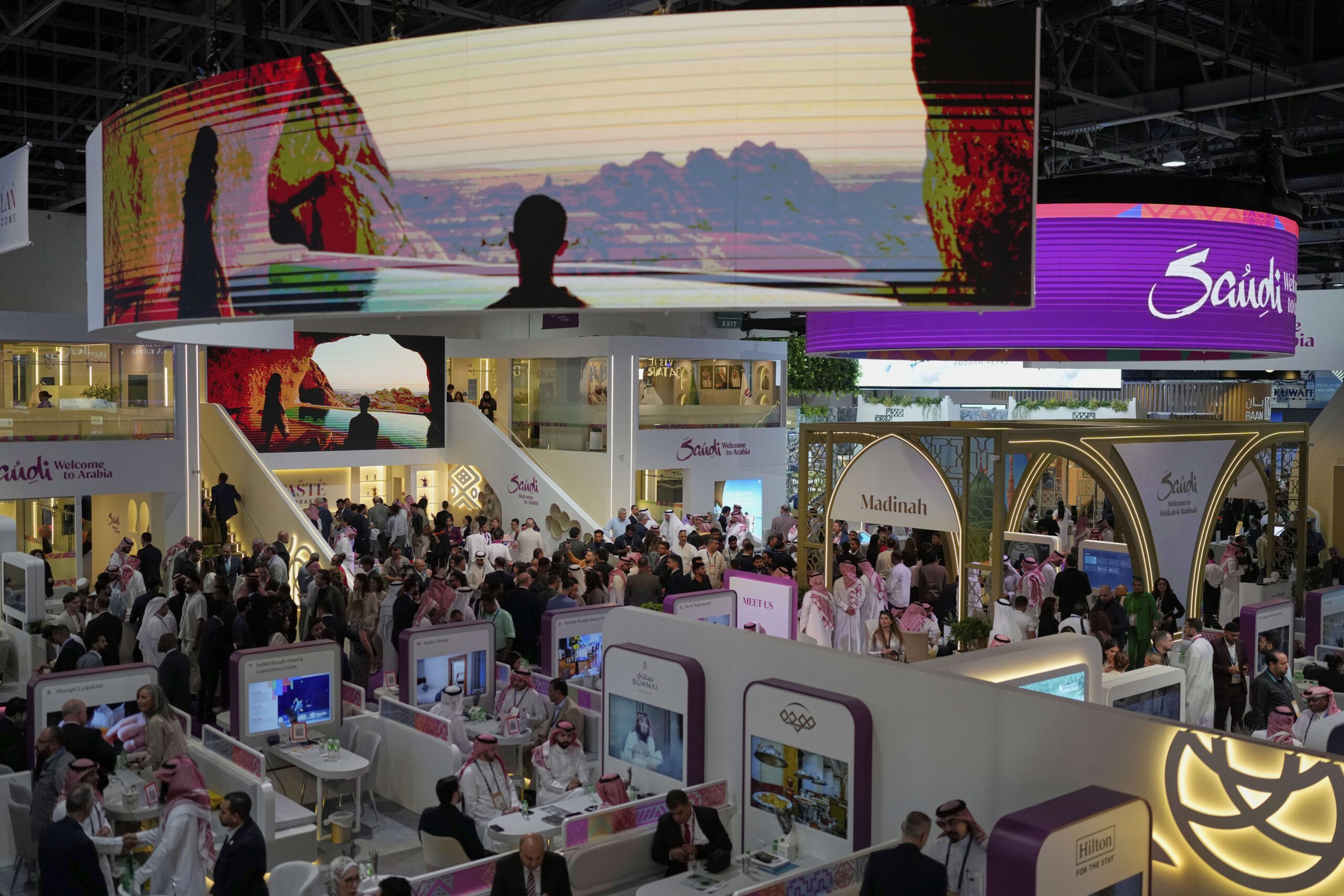 Delegates visit Saudi Arabia's pavilion during the Arabian Travel Market exhibition in Dubai, United Arab Emirates, April 29. (AP Photo/Altaf Qadri)