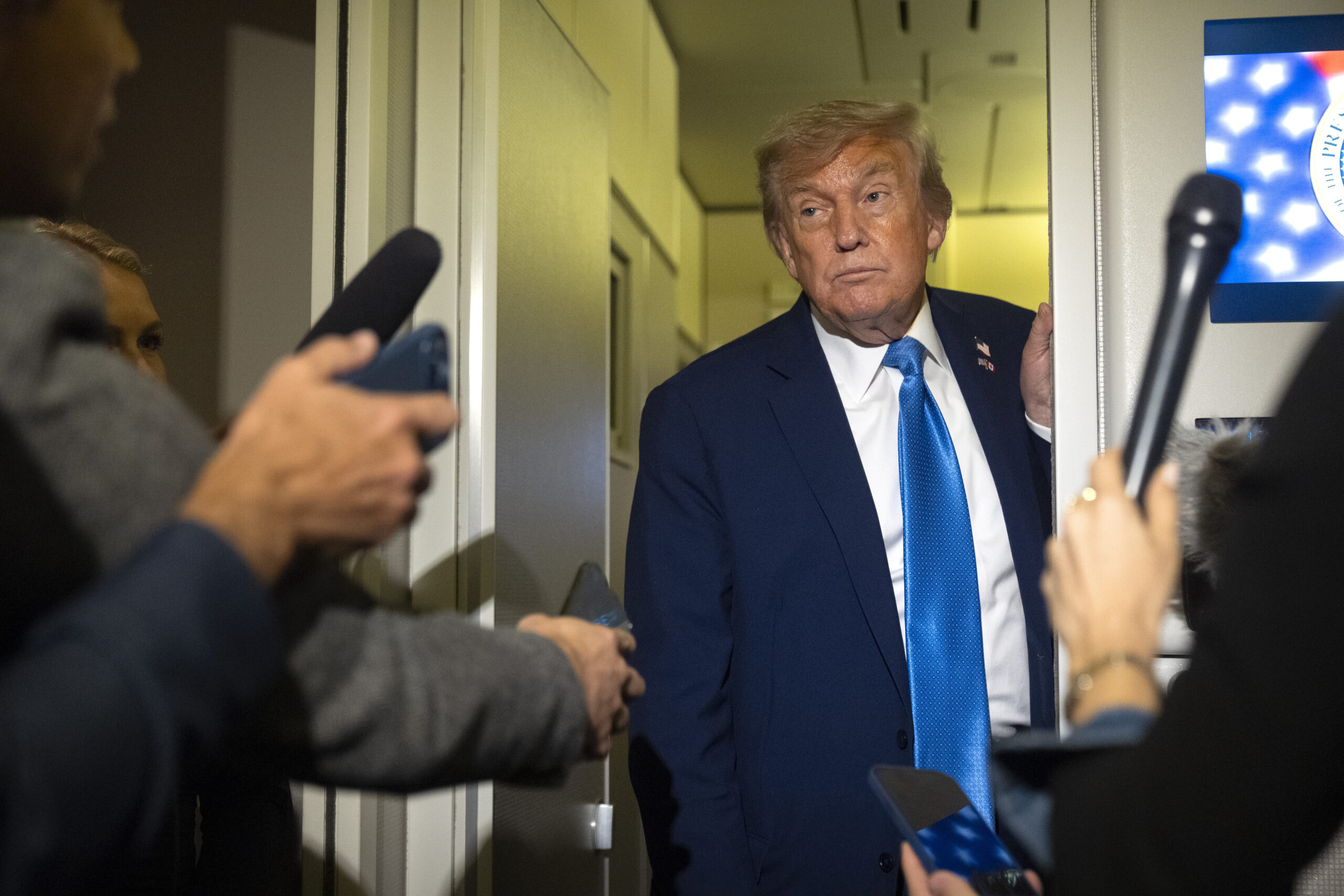 President Donald J. Trump speaks with reporters while flying aboard Air Force One en route from Calgary, Canada to Joint Base Andrews, Md., June 16. (AP Photo/Mark Schiefelbein)