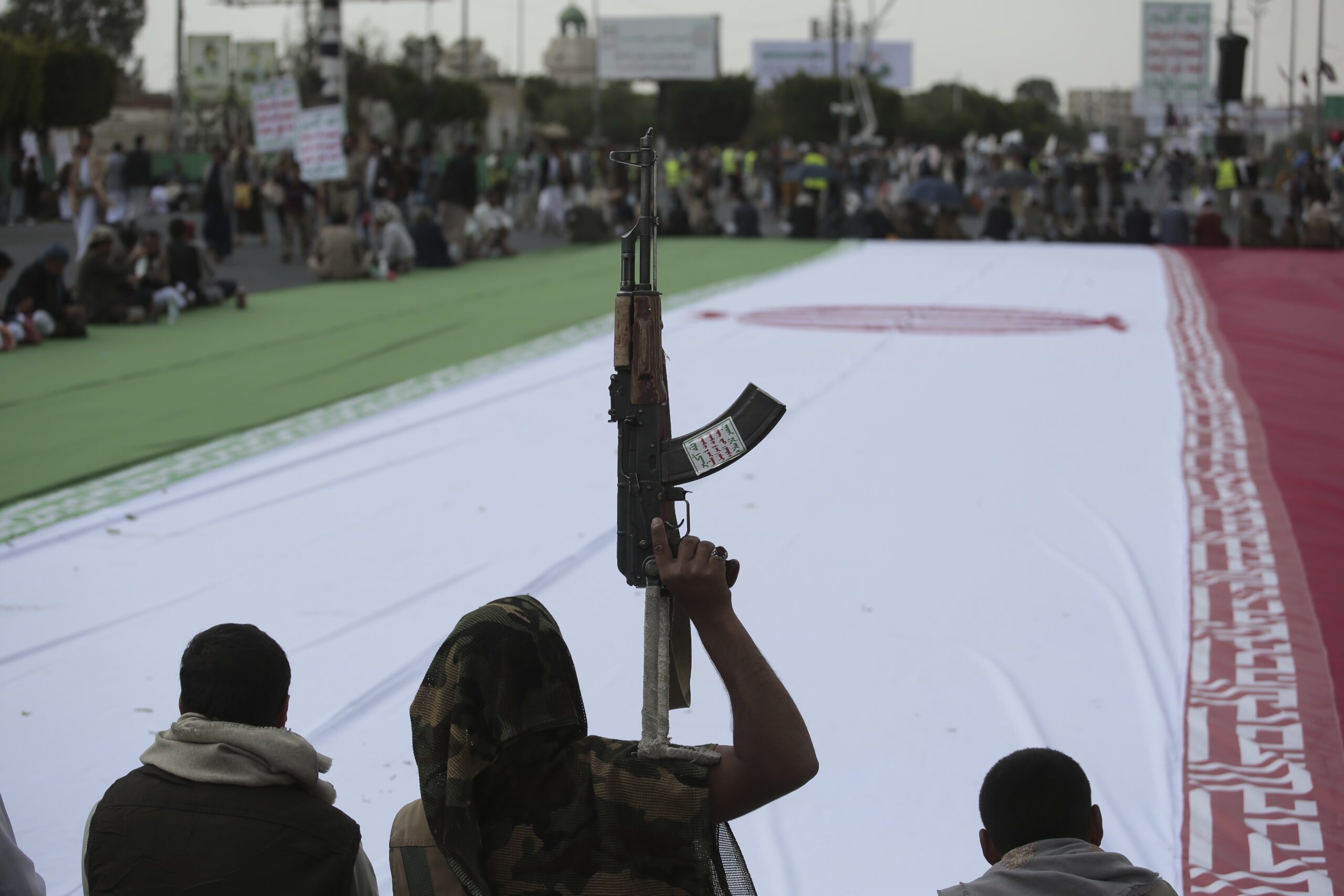 Houthi supporters surround a giant Iranian flag during an anti-U.S. and anti-Israel weekly rally in Sanaa, Yemen, June 20. (AP Photo/Osamah Abdulrahman)