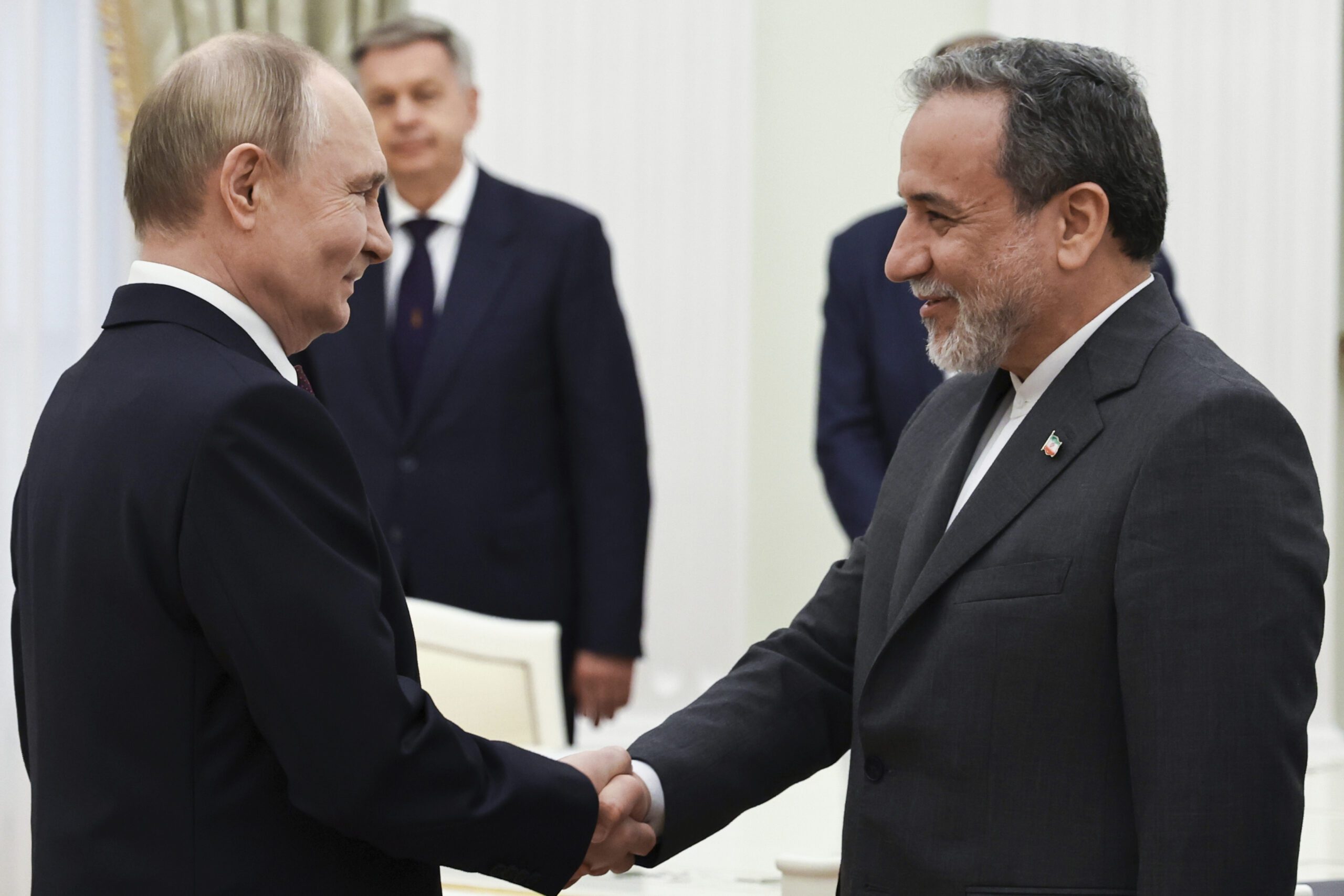 Russian President Vladimir Putin greets Iranian Foreign Minister Abbas Araghchi prior to their talks at the Kremlin in Moscow, Russia, June 23. (Alexander Kazakov, Sputnik, Kremlin Pool Photo via AP)