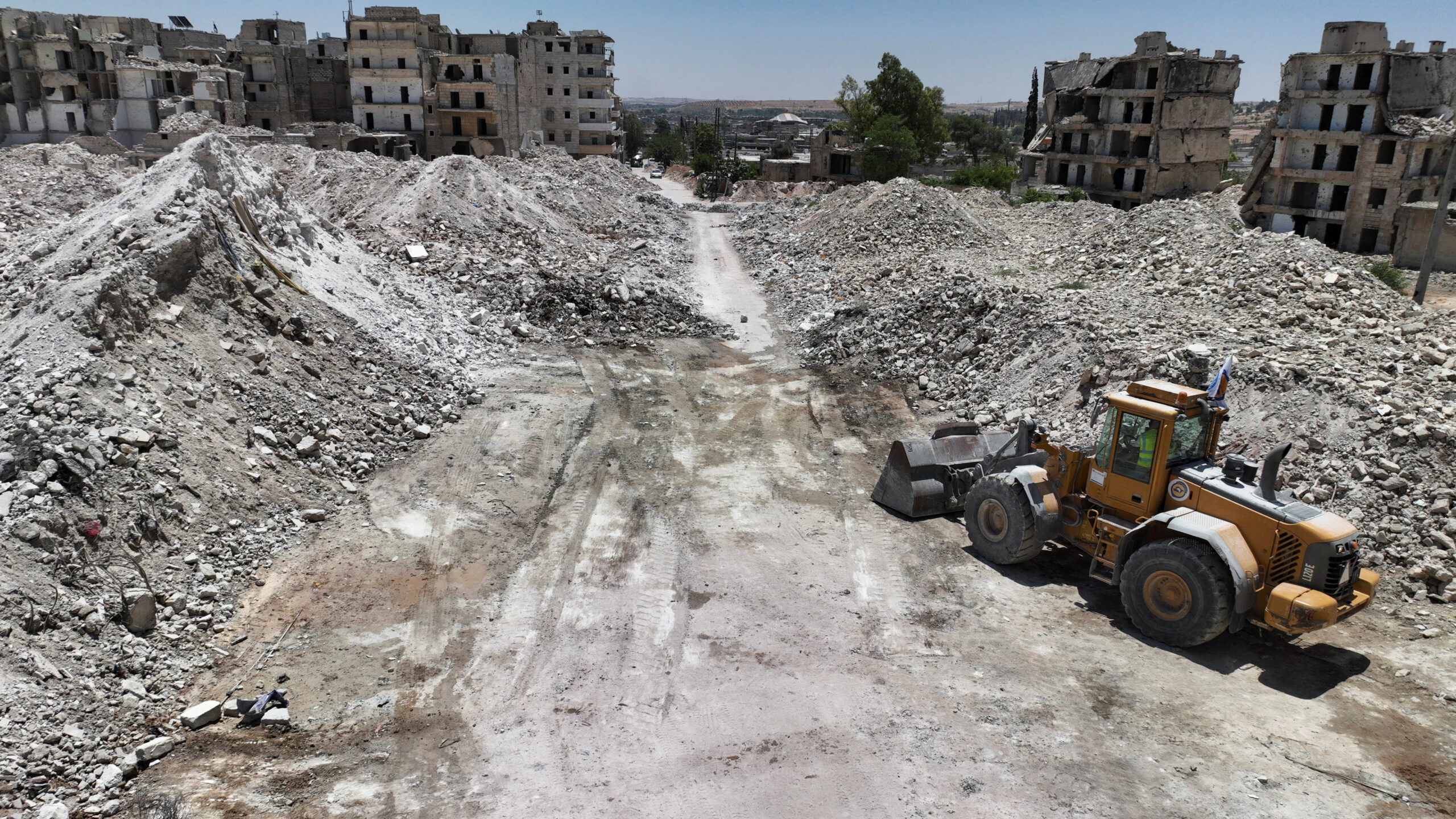 A drone view shows destroyed buildings and massive piles of rubble, as a bulldozer stands nearby, in Aleppo, Syria, June 24. (REUTERS/Mahmoud Hassano)