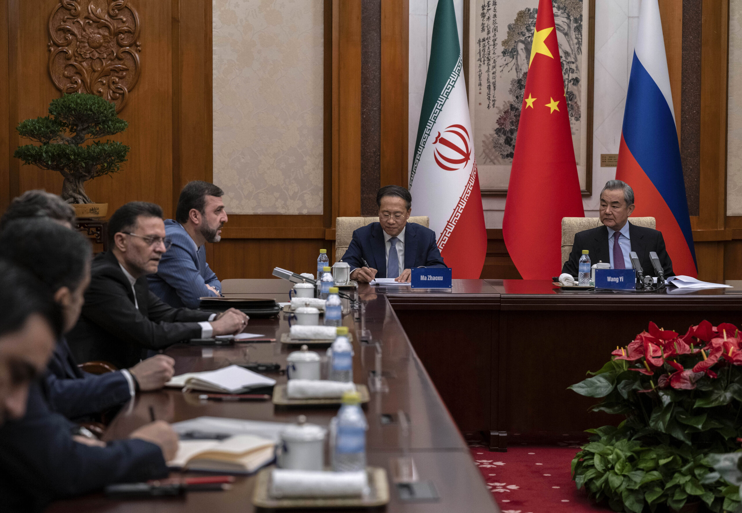 Chinese Foreign Minister Wag Yi and Vice Foreign Minister Ma Zhaoxu listen to Iranian Deputy Foreign Minister Kazeem Gharibabadi speak during a meeting regarding the Iranian nuclear issue at Diaoyutai State Guest House on March 14 in Beijing, China. (Pool Photo via AP)