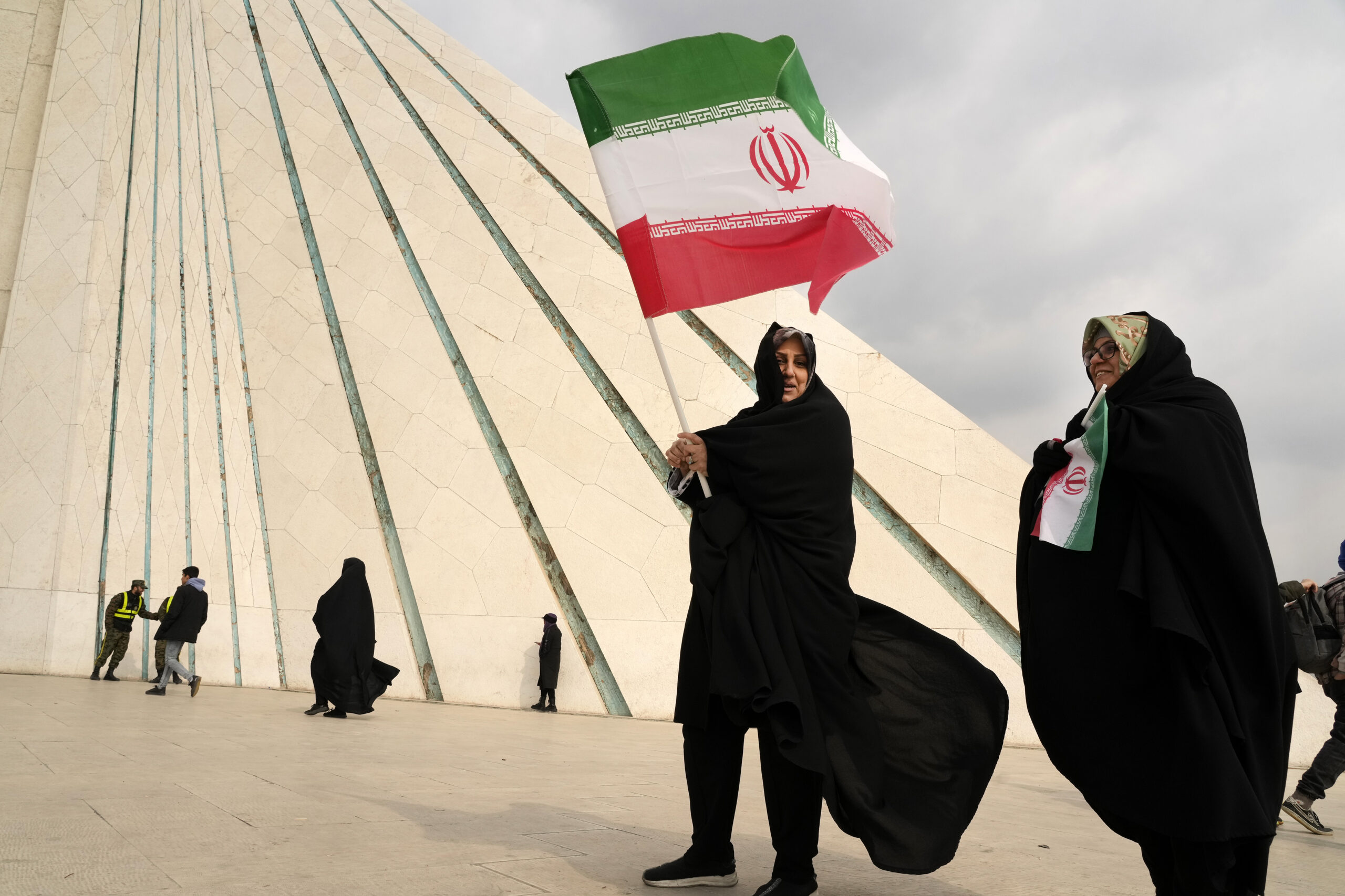Women carry Iranian flags under the Azadi (freedom) monument tower during a rally commemorating the anniversary of the 1979 Islamic Revolution in Tehran, Iran, Feb. 10. (AP Photo/Vahid Salemi)