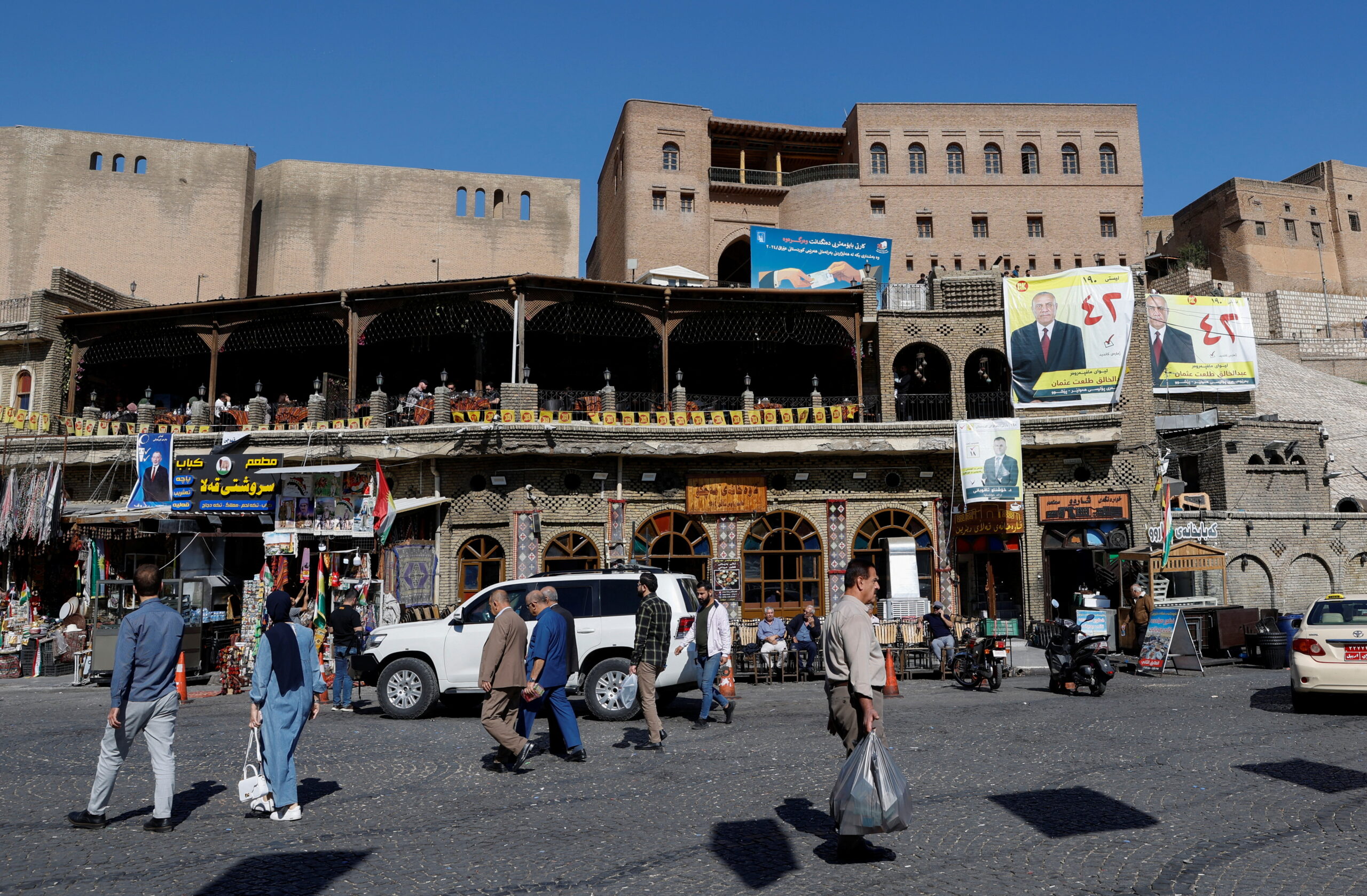 People walk in the street, one day after the Iraq's Kurdistan region parliamentary election, in Erbil, Iraq October 21, 2024. (REUTERS/Khalid Al-Mousily)