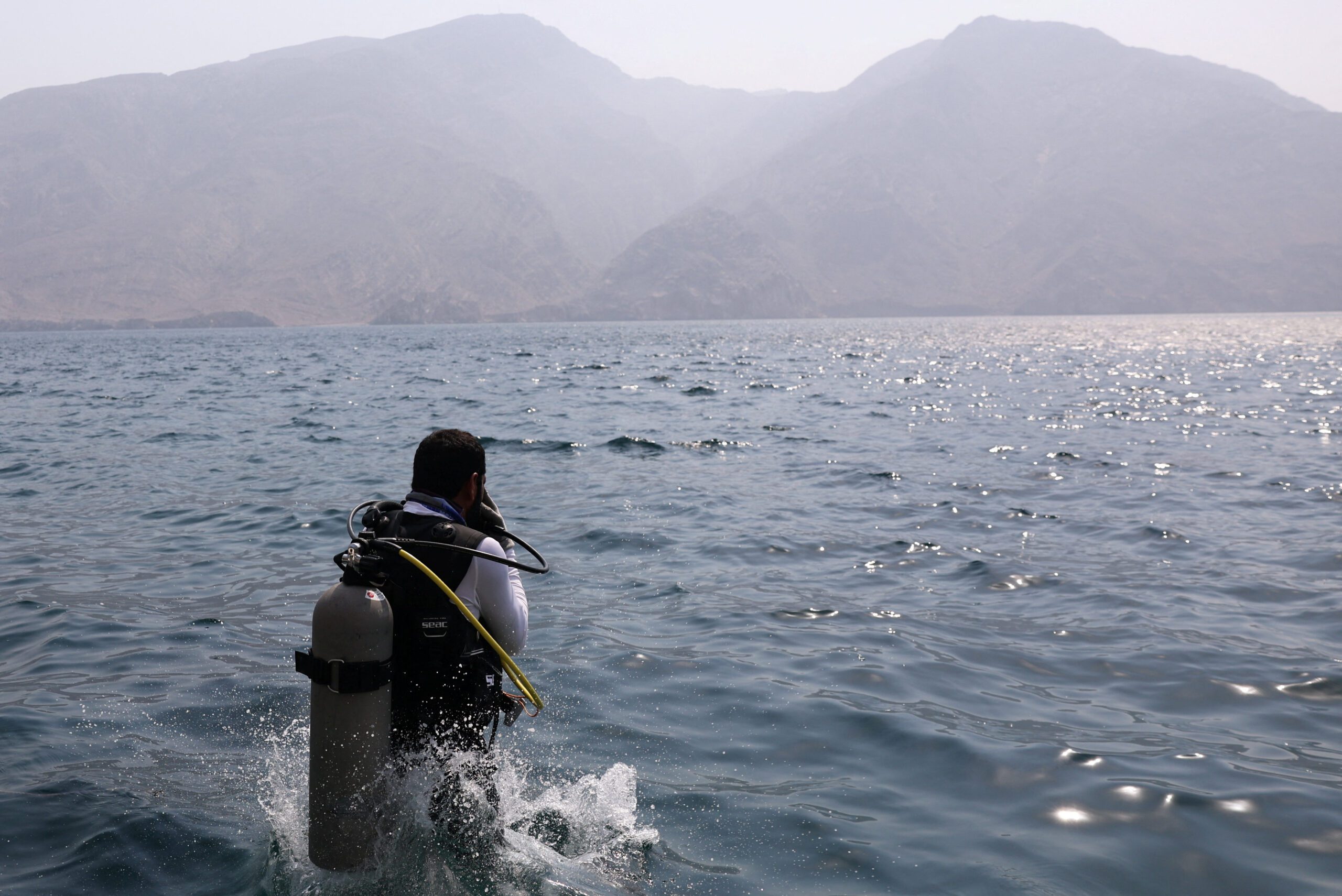 A diver jumps into the water at a location off the coast of Musandam to implant coral during the first Musandam International Diving Festival, in Oman, August 26. (REUTERS/Amr Alfiky)