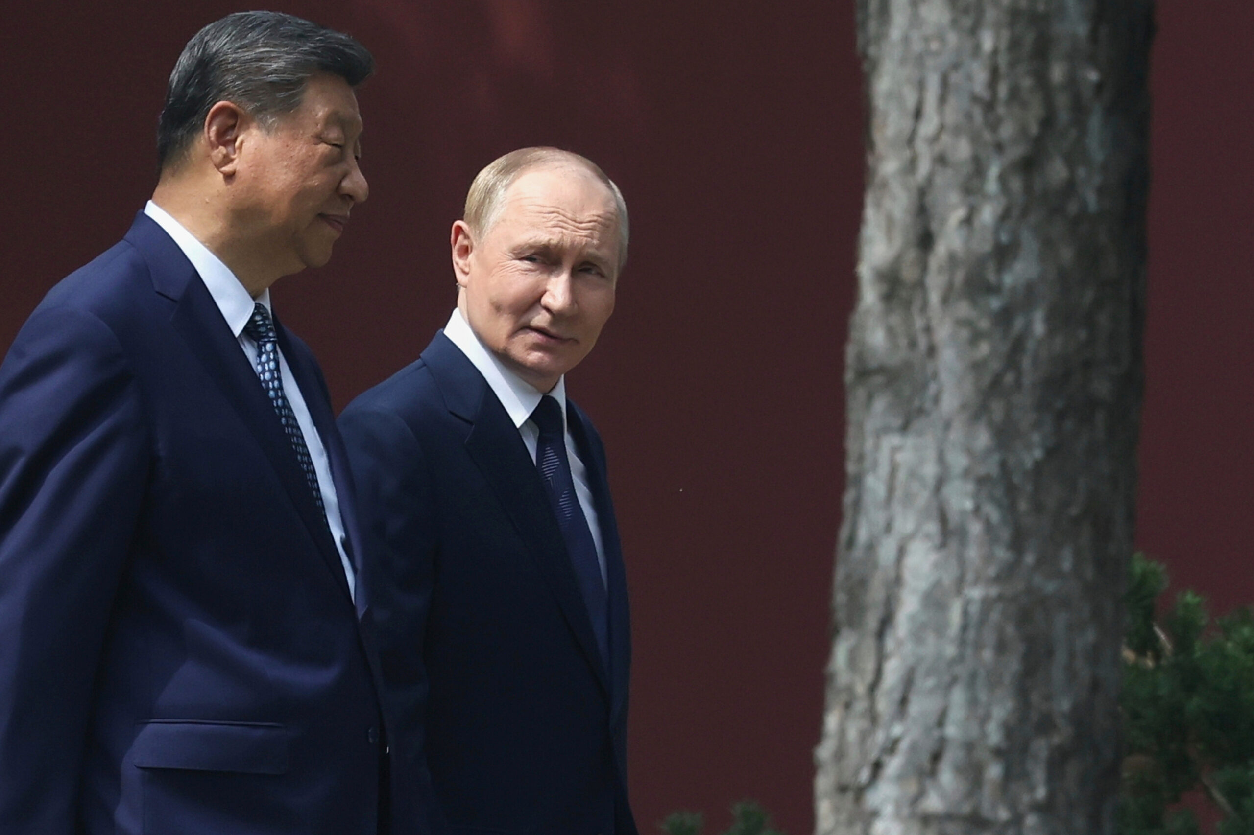Russian President Vladimir Putin speaks with Chinese President Xi Jinping during a walk at the Zhongnanhai leadership compound in Beijing, China, Sept. 2. (Alexander Kazakov, Sputnik, Kremlin Pool Photo via AP)
