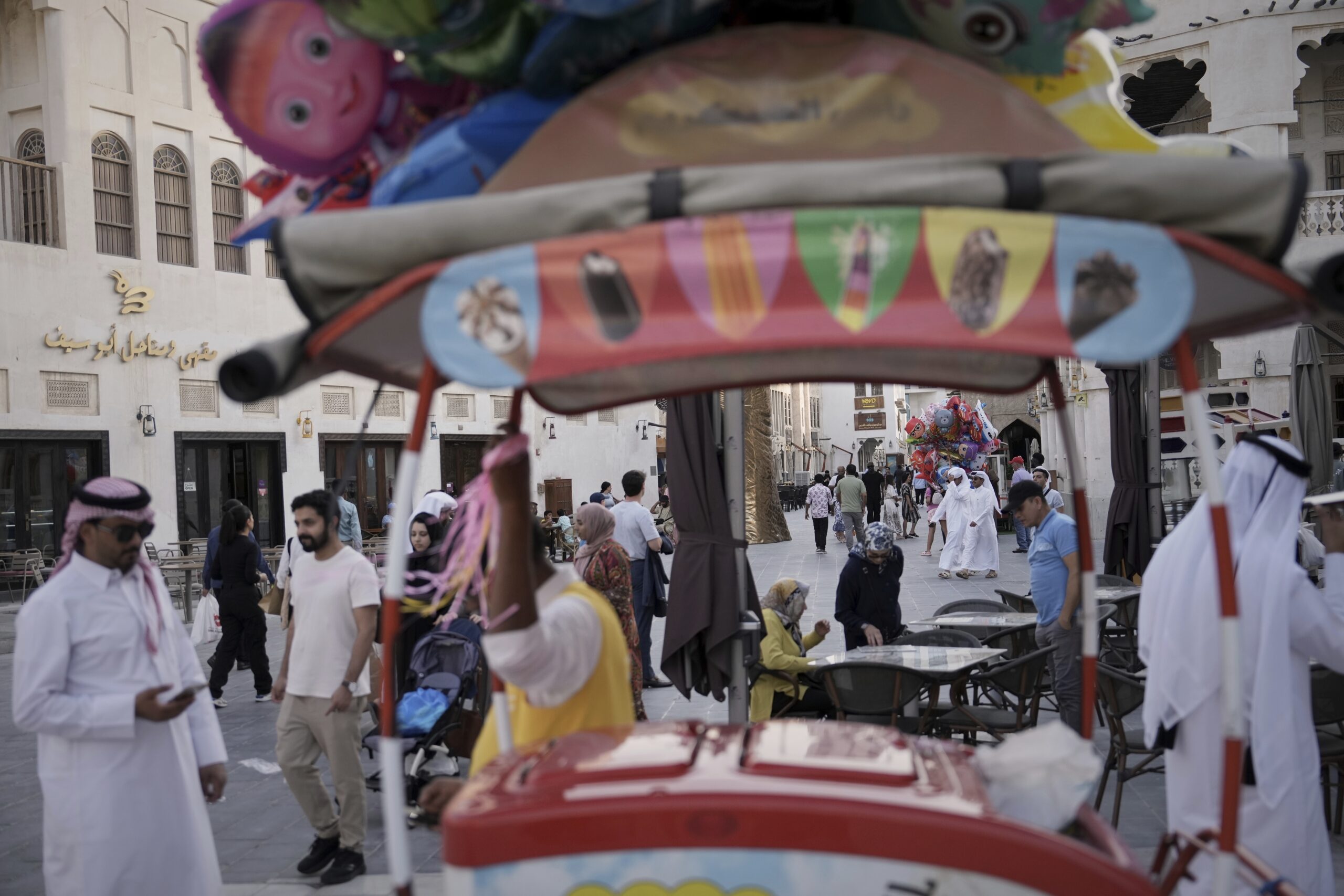 Tourists and locals stroll through Souq Waqif in Doha, Qatar, May 15. (AP Photo/Fatima Shbair)