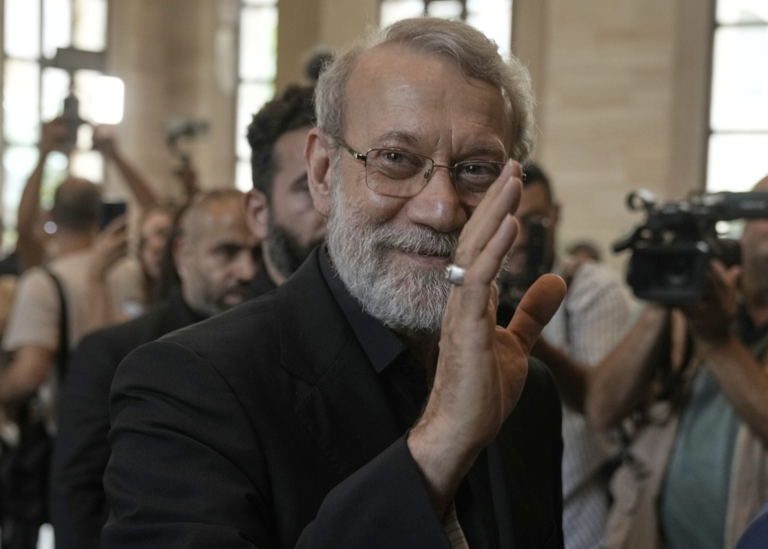 Iranian Secretary of Supreme National Security Council Ali Larijani, greets journalists upon his arrival to meet with the Lebanese parliament speaker Nabih Berri, in Beirut, Lebanon, Aug. 13. (AP Photo/Bilal Hussein)