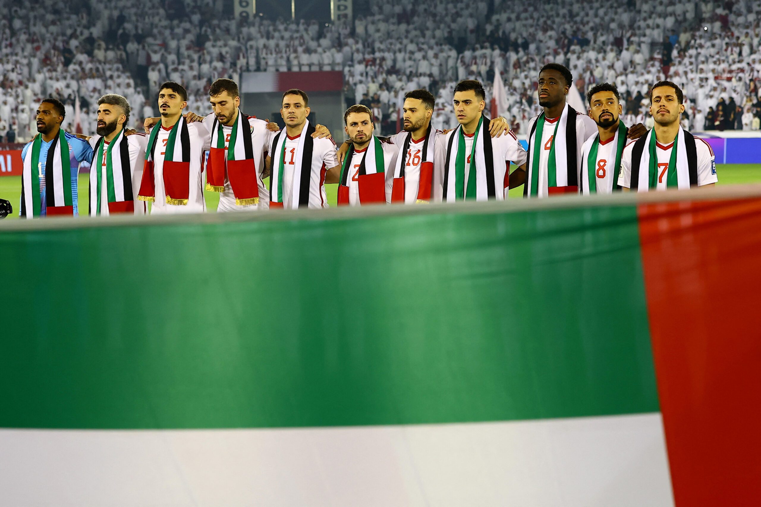 United Arab Emirates players line up during the national anthems before a match, October 14, 2025. (REUTERS/Ibraheem Al Omari)