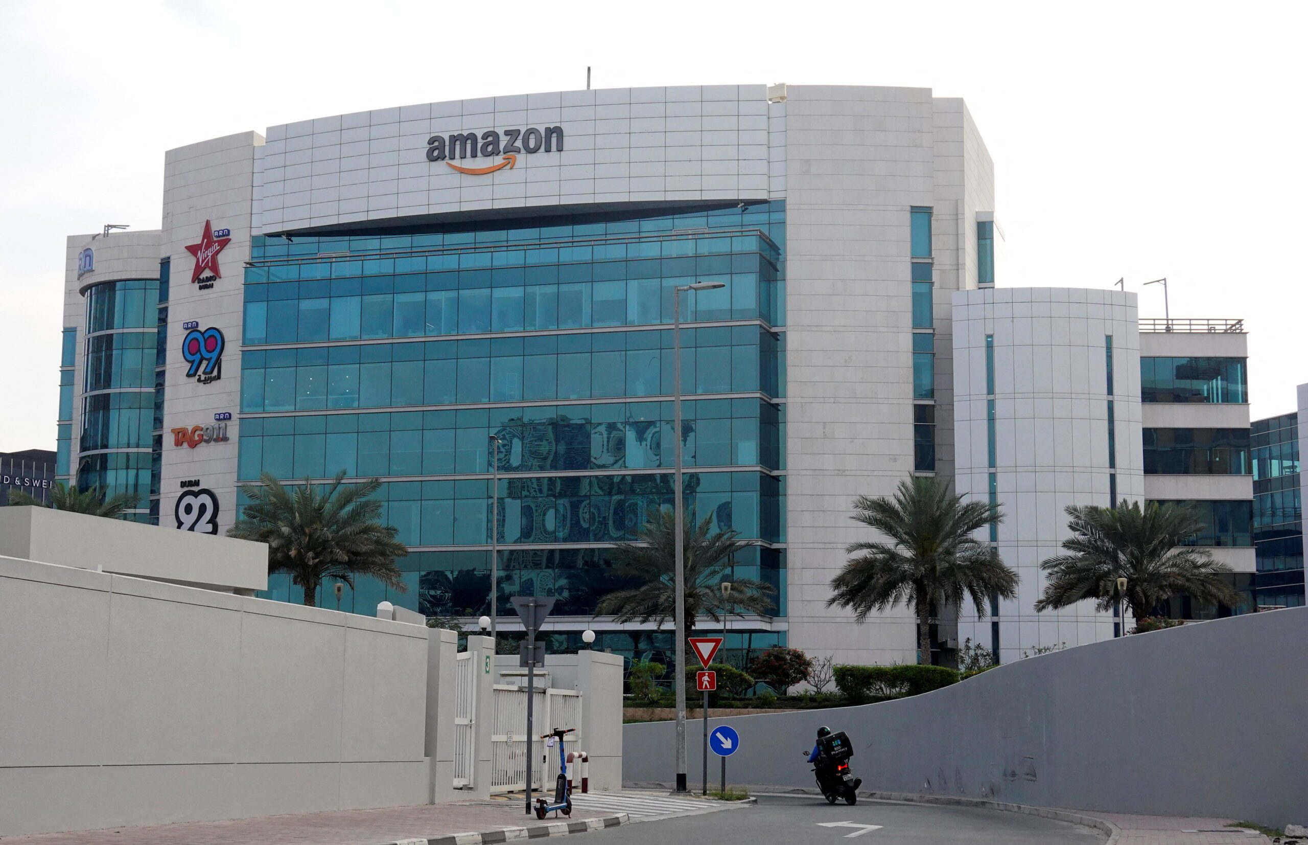 A delivery personnel rides a motobike in front of a building with the Amazon sign displayed amid the U.S.-Israeli war with Iran, in Dubai, the United Arab Emirates, March 7. (REUTERS/Amr Alfiky)