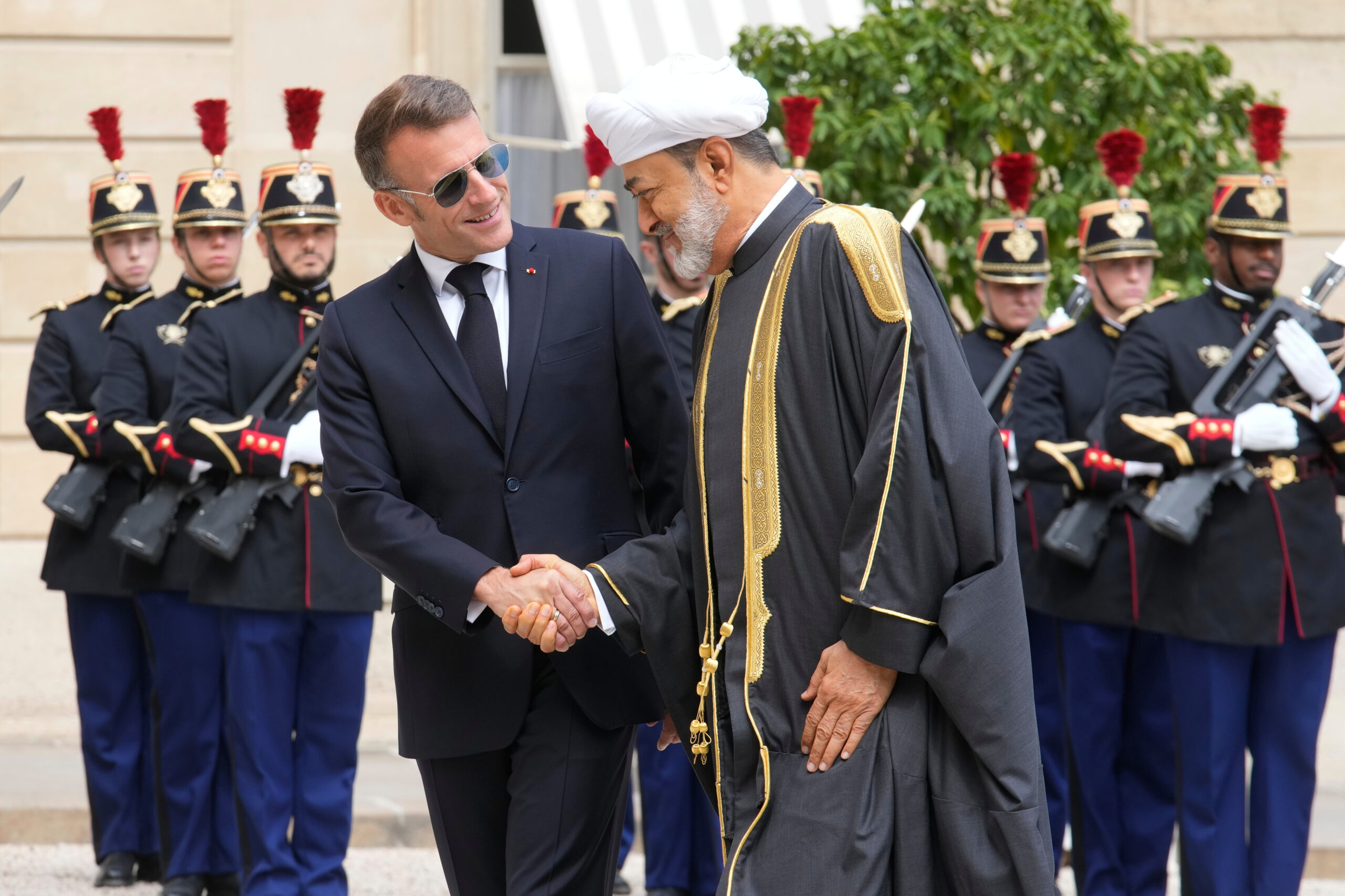 French President Emmanuel Macron, left, greets Omani Sultan Haitham bin Tariq al-Said before a meeting at the Elysee Palace, in Paris, June 29. (AP Photo/Michel Euler)