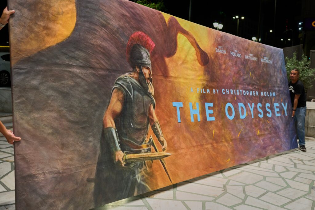 Workers install a hand-painted billboard, painted by artist Virginia Axioti, for Christopher Nolan’s film “The Odyssey,” starring Matt Damon as Odysseus, outside Athens’ Athinaion cinema, July 11. (AP Photo/Petros Giannakouris)