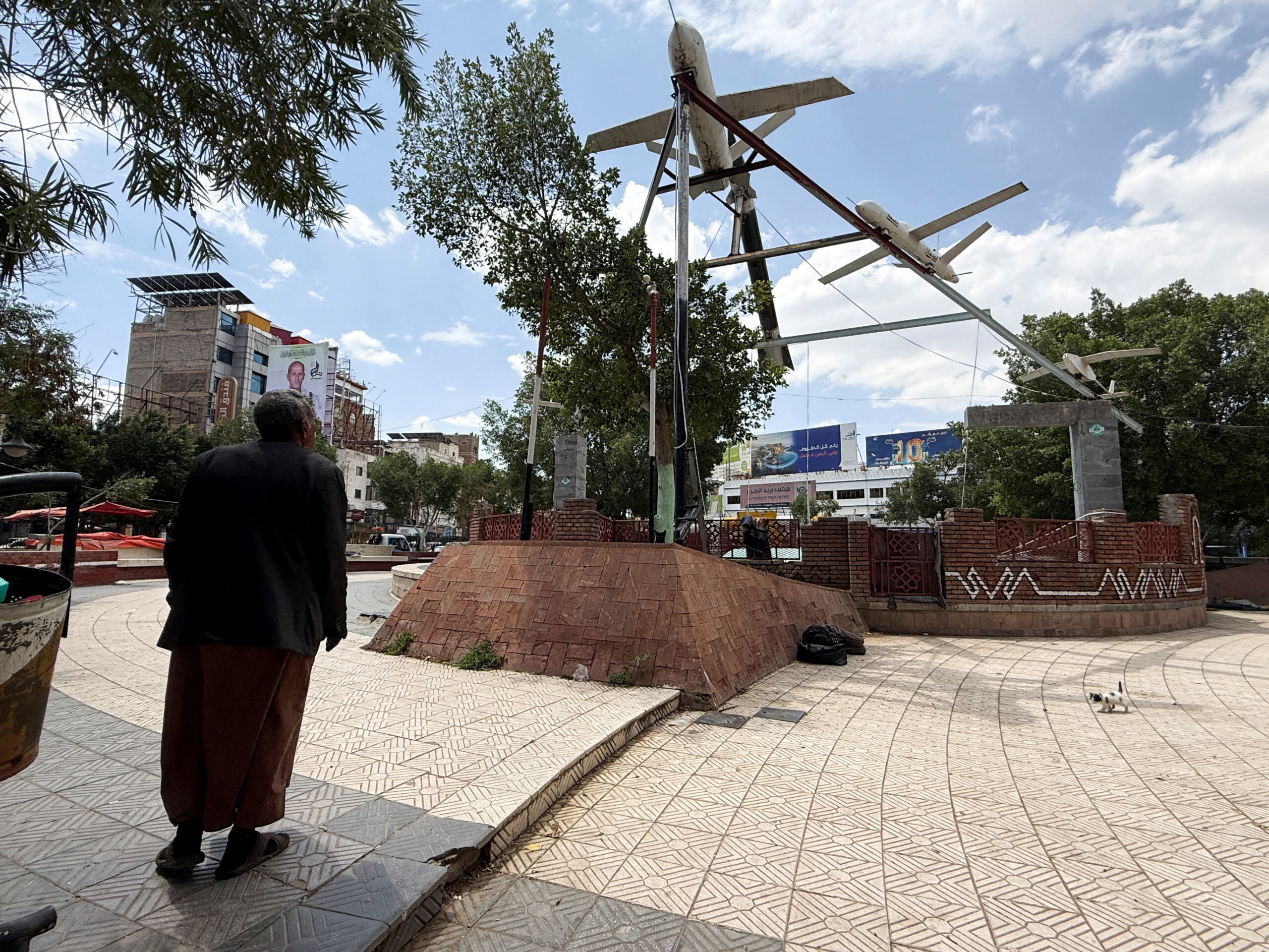 A man walks past mock drones put on display in Tahreer Square in Sanaa, Yemen, September 15. (REUTERS/Adel Al Khader)