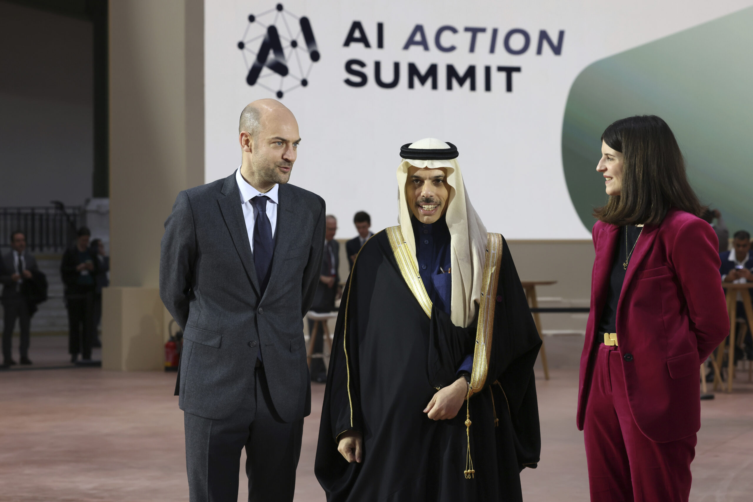 Saudi Foreign Minister Faisal bin Farhan, center, is welcomed by French Foreign Minister Jean-Noel Barrot, left, and French businesswoman Clara Chappaz at the Grand Palais during the Artificial Intelligence Action Summit in Paris, February 11, 2025. (AP Photo/Thomas Padilla)